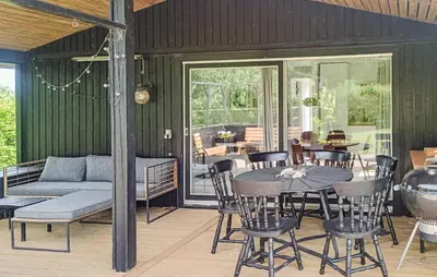 a patio with a table and chairs and a couch at 3 Bedroom Cozy Home In Vinderup in Vinderup