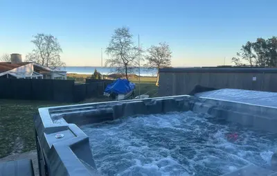 a hot tub with water in a backyard at 3 Bedroom Cozy Home In Højslev in Højslev