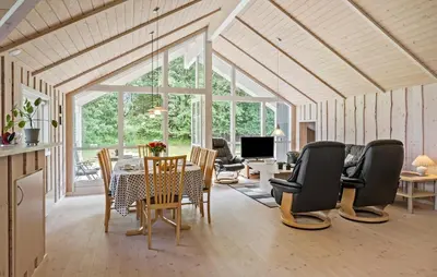 a living room with a table and chairs at 3 Bedroom Cozy Home In Højslev in Højslev