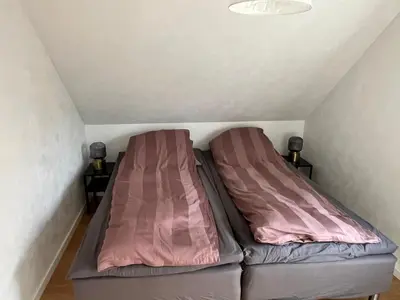 two beds in a small room in a attic at Thisted Centrum in Thisted