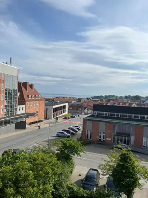 a city with cars parked in a parking lot at Thisted Centrum in Thisted
