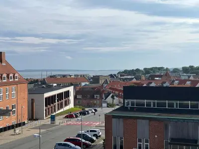 a city with cars parked in a parking lot at Thisted Centrum in Thisted