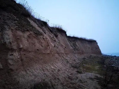 a cliff with a fence on top of it at 4 star holiday home in Øster Assels-By Traum in Øster Assels