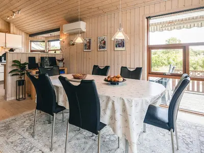 a kitchen and dining room with a table and chairs at 4 star holiday home in Øster Assels-By Traum in Øster Assels