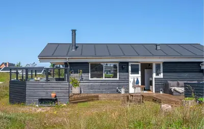 a blue house with a porch and a deck at 2 Bedroom Lovely Home In Thisted in Thisted
