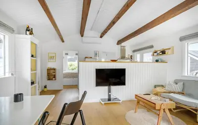 a living room with a fireplace and a tv at 2 Bedroom Lovely Home In Thisted in Thisted
