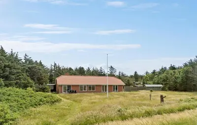 a house in the middle of a field at 4 Bedroom Beach Front Home In Thyholm in Thyholm