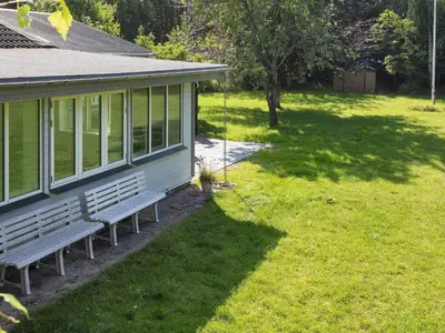 a bench in a yard next to a house at 4 star holiday home in Gedsted-By Traum in Gedsted