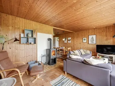 a living room with a couch and a fireplace at Holiday Home Arlin - 380m to the fjord by Interhome in Vemb