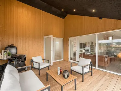 a living room with two chairs and a table at Holiday Home Dreng - 300m from the sea by Interhome in Harboør