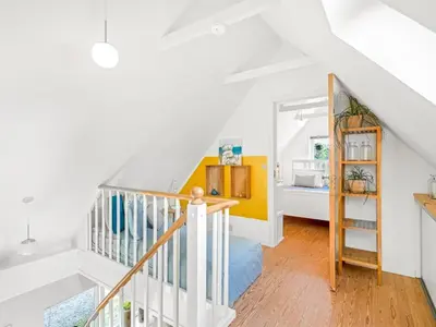 a white staircase in a white room with a bedroom at Holiday Home Cillvur - 8km from the sea by Interhome in Thisted