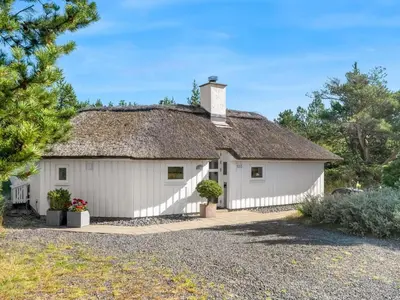 a white building with a thatched roof at Holiday Home Pihla - 1-1km from the sea by Interhome in Fjerritslev