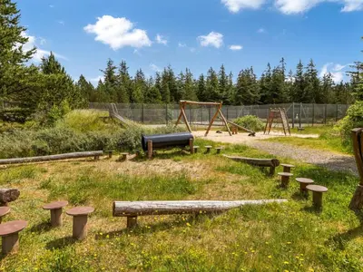 a park with a playground with a slide at Holiday Home Pihla - 1-1km from the sea by Interhome in Fjerritslev