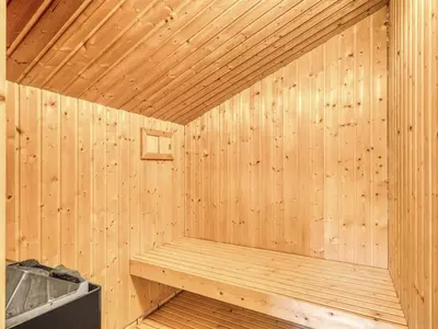 a wooden sauna with a bench in it at Holiday Home Ane - 800m from the sea by Interhome in Fjerritslev