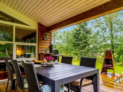an outdoor dining room with a table and chairs at Holiday Home Zölestine - from the sea by Interhome in Fjerritslev