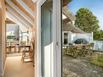 an open door to a patio with a table and chairs at Holiday Home Elenor - 1-1km from the sea by Interhome in Fjerritslev