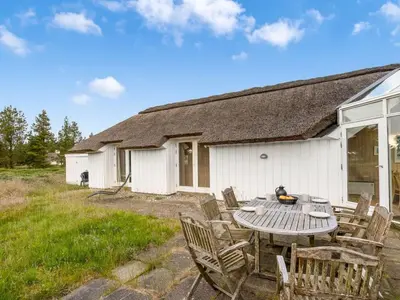 a table and chairs in front of a house at Holiday Home Elenor - 1-1km from the sea by Interhome in Fjerritslev