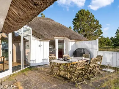 a patio with a table and chairs in front of a house at Holiday Home Elenor - 1-1km from the sea by Interhome in Fjerritslev