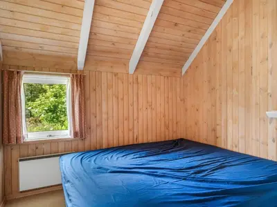 a bed in a room with a window at Holiday Home Elenor - 1-1km from the sea by Interhome in Fjerritslev