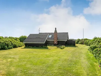 an image of a barn with a large grass yard at Holiday Home Angelie - 400m from the sea by Interhome in Harboør