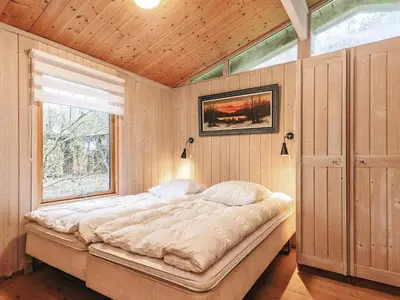 a large bed in a room with a window at 7 person holiday home in Vestervig-By Traum in Vestervig