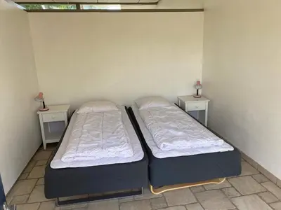 two beds in a room with two night stands at Light-filled Retreat in Boddum - By Traum Ferienwohnungen in Boddum