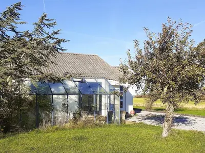 a glass house with a tree in front of it at Light-filled Retreat in Boddum - By Traum Ferienwohnungen in Boddum
