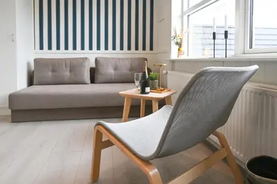 a chair and a table in a living room with a couch at Rold Gl Kro in Arden
