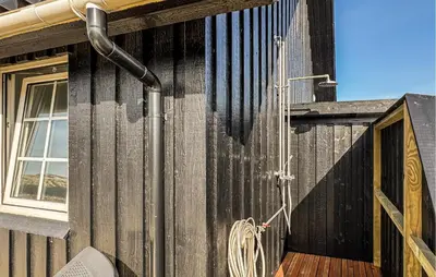 a side view of a building with a shower on it at 2 Bedroom Stunning Home In Harboøre in Harboør