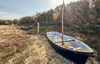 a small boat sitting on the ground in a field at 2 Bedroom Stunning Home In Harboøre in Harboør