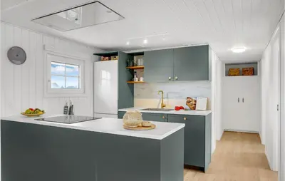 a kitchen with blue cabinets and a white counter top at 2 Bedroom Stunning Home In Harboøre in Harboør