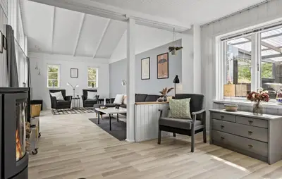 a living room with a table and chairs at 4 Bedroom Lovely Home In Vestervig in Vestervig
