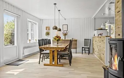 a dining room with a wooden table and chairs at 4 Bedroom Lovely Home In Vestervig in Vestervig