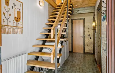 a wooden spiral staircase in a room with a hallway at Stunning Home In Højslev With Wifi in Højslev