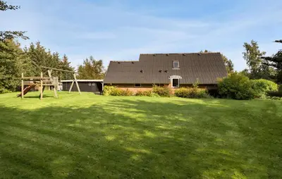 a house with a large yard with a playground at 3 Bedroom Stunning Home In Højslev in Højslev
