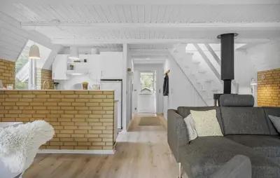 a living room with a couch and a kitchen at 3 Bedroom Stunning Home In Højslev in Højslev