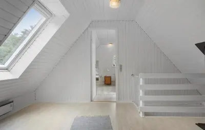 a white staircase in a attic with a window at 3 Bedroom Stunning Home In Højslev in Højslev