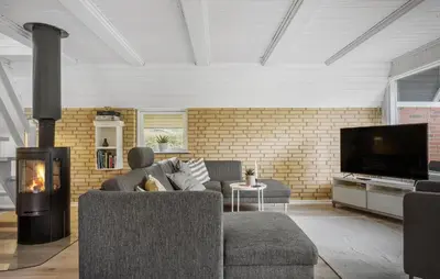 a living room with a couch and a fireplace at 3 Bedroom Stunning Home In Højslev in Højslev