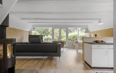 a living room with a couch and a fireplace at 3 Bedroom Stunning Home In Højslev in Højslev