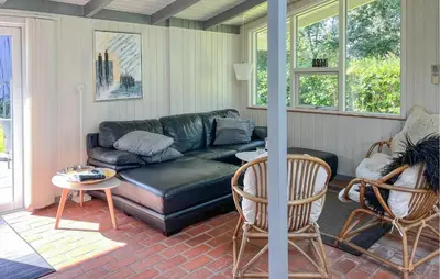 a living room with a black leather couch and chairs at 3 Bedroom Beautiful Home In Vinderup in Vinderup