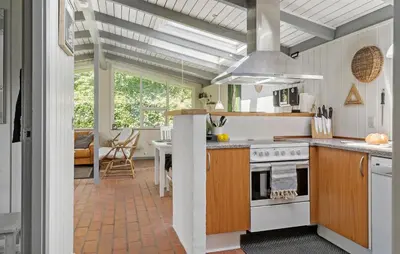 a kitchen with a stove and a dining room at 3 Bedroom Beautiful Home In Vinderup in Vinderup
