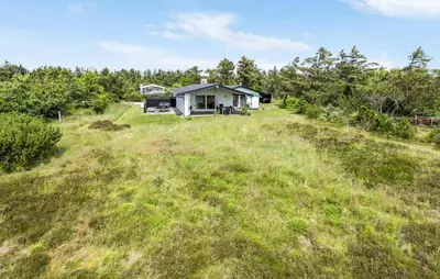 a house on a hill with a grassy field at Lovely Home In Hurup Thy With Wifi in Sindrup