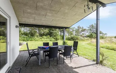 a patio with a table and chairs on it at Lovely Home In Hurup Thy With Wifi in Sindrup