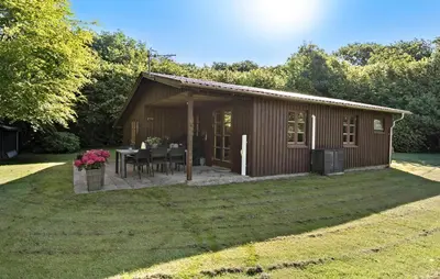 a small cabin with a table in the yard at 3 Bedroom Nice Home In Farsø in Farsø