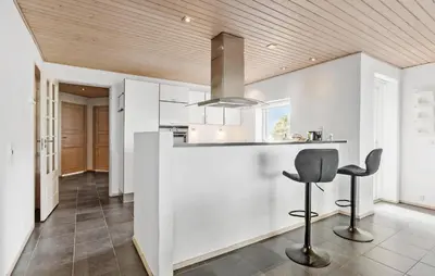 a kitchen with a counter and two stools at Amazing Home In Vesløs With Wifi in Øsløs
