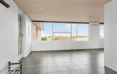 a large room with white walls and a large window at Amazing Home In Vesløs With Wifi in Øsløs