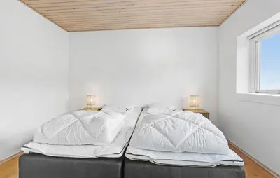 a bedroom with white walls and a bed with pillows at Amazing Home In Vesløs With Wifi in Øsløs