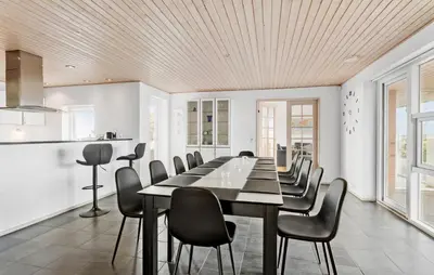 a dining room with a long table and chairs at Amazing Home In Vesløs With Wifi in Øsløs