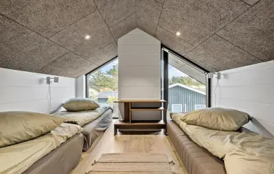 a room with two large couches in front of a window at 4 Bedroom Pet Friendly Home In Blokhus in Blokhus