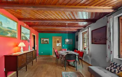 a dining room with a table and red chairs at 5 Bedroom Beautiful Home In Brovst in Brovst